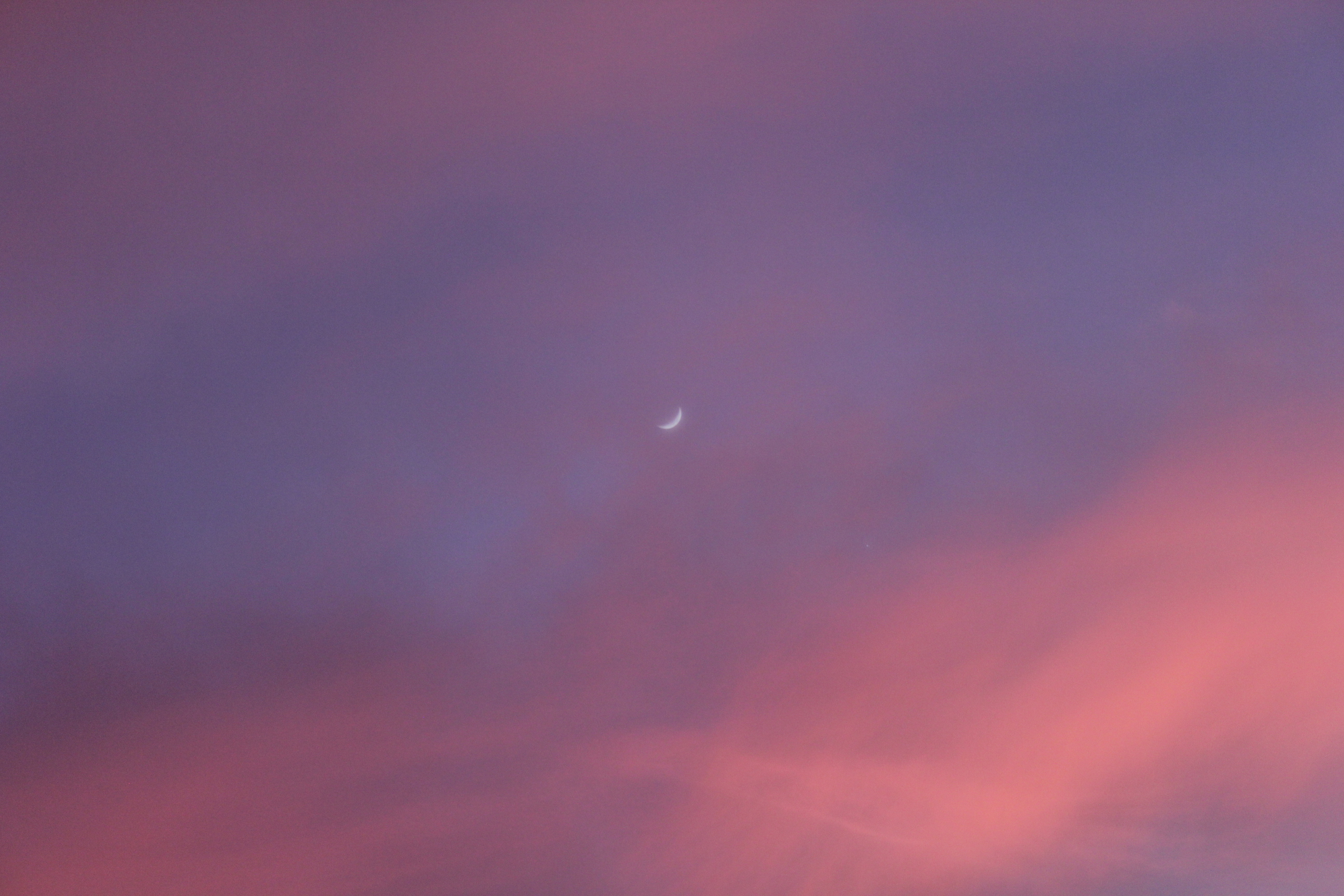 Purple sunset sky with crescent moon